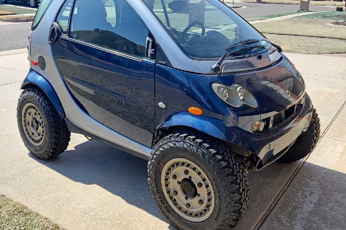 Lifted blue and silver Smart Fortwo 450 on off-road tires and steel wheels