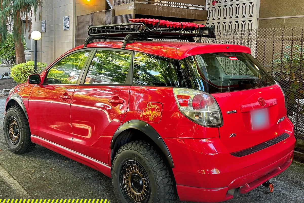 Rear view of a lifted red Toyota Matrix with fender flares, roof rack and the Little Big Supply 2" lift kit