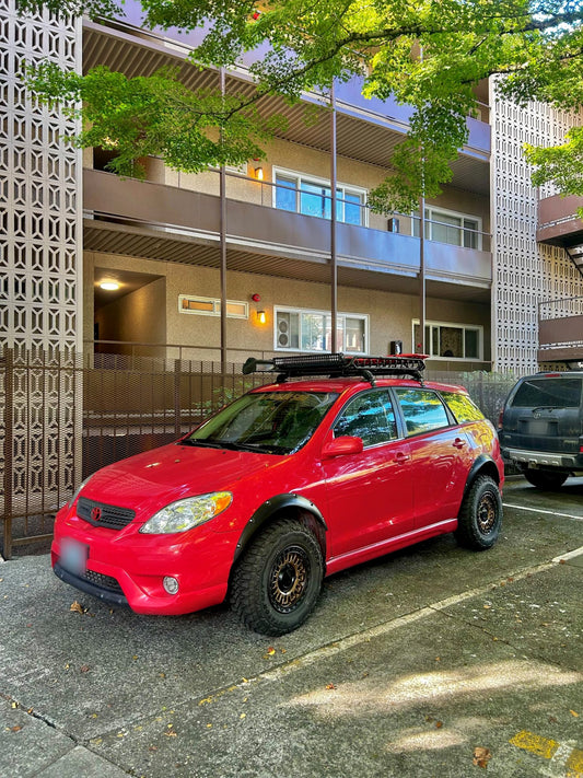 Lifted red Toyota Matrix with the Little Big Supply 2" Toyota lift kit, front three-quarter view